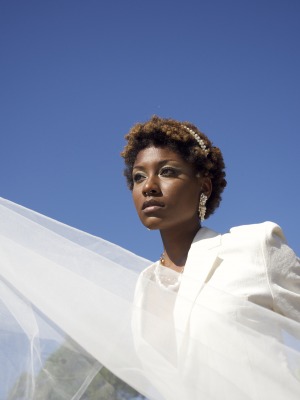 Photo of model in white dress.