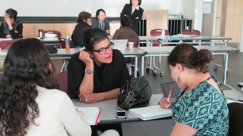 3 HCI Students sitting at table studying